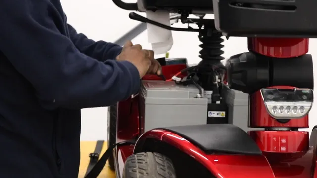Person installing mobility scooter batteries